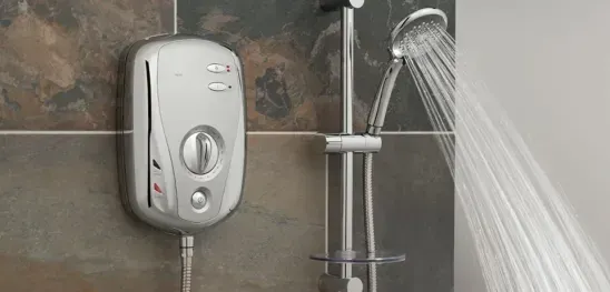A shower head is spraying water in a bathroom.