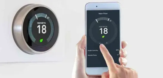 A person is using a smart phone to control a thermostat.