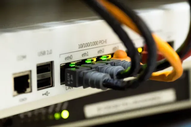 A close up of a computer with a bunch of wires plugged into it