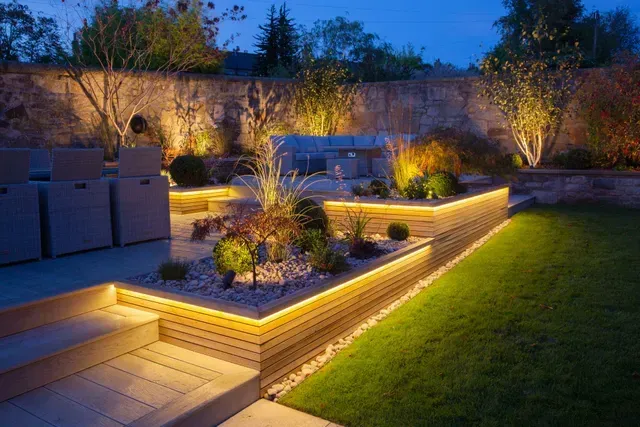 A garden with a lot of lights on it at night.